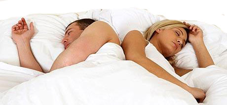 Couple asleep in bed