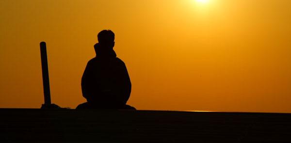 Man at sunset reflecting