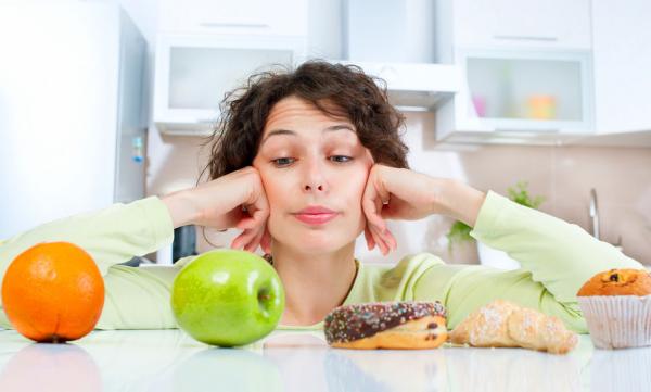 Lady deciding fruit or cake